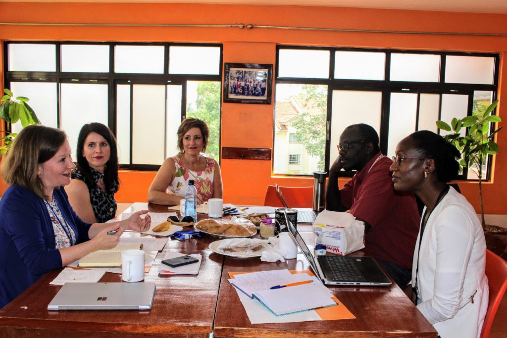 Representatives from Glen Haven Manor, Pictou County Regional Enterprise Network and RefugePoint discussing the partnership in Nairobi. November 2019. (Left to right: Sarah MacIntosh‑Wiseman, CEO of Pictou County Regional Enterprise Network (PCREN), Janice Jorden, Glen Haven Manor Employee Relations Specialist, Lisa M. Smith, Glen Haven Manor CEO, Jacob Bonyo, Country Director of the RefugePoint Kenya office, and Janet Ouma, Resettlement Program Coordinator for RefugePoint. 