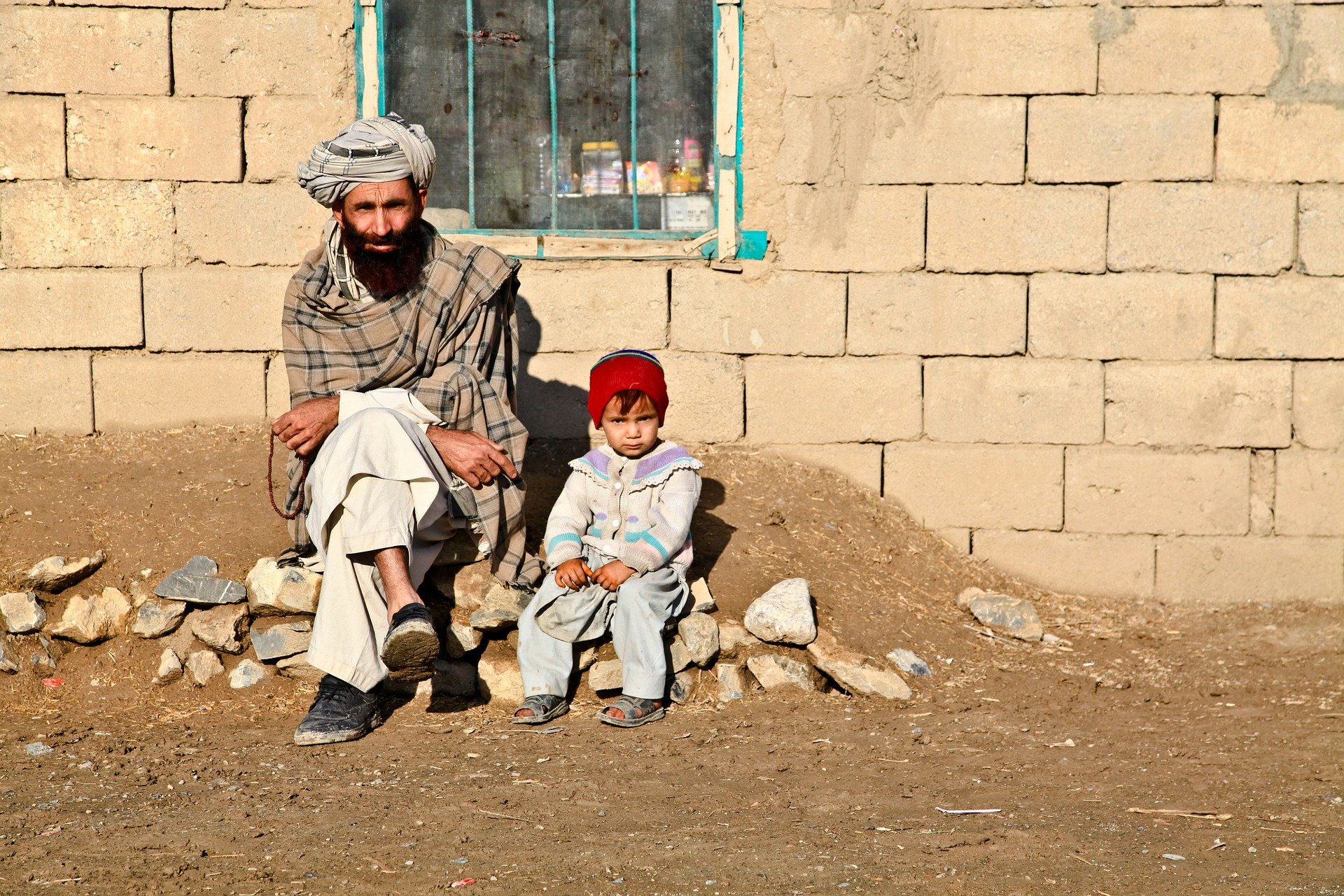 An afghan man with his daughter