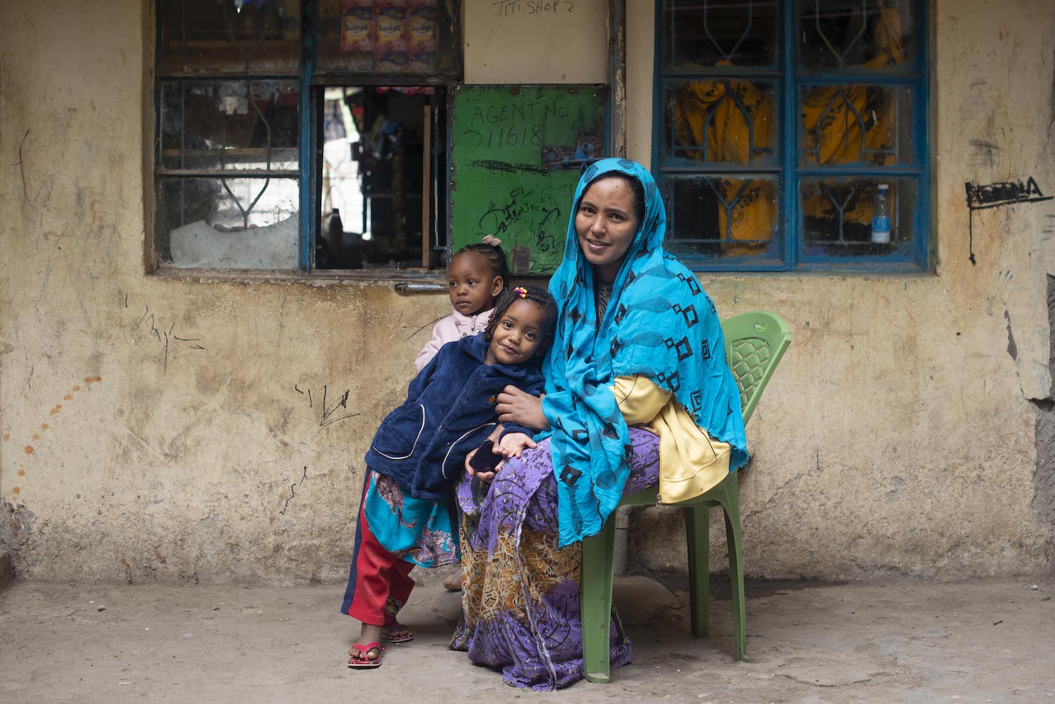 A woman with her two children, seeking support and assistance for their livelihood on