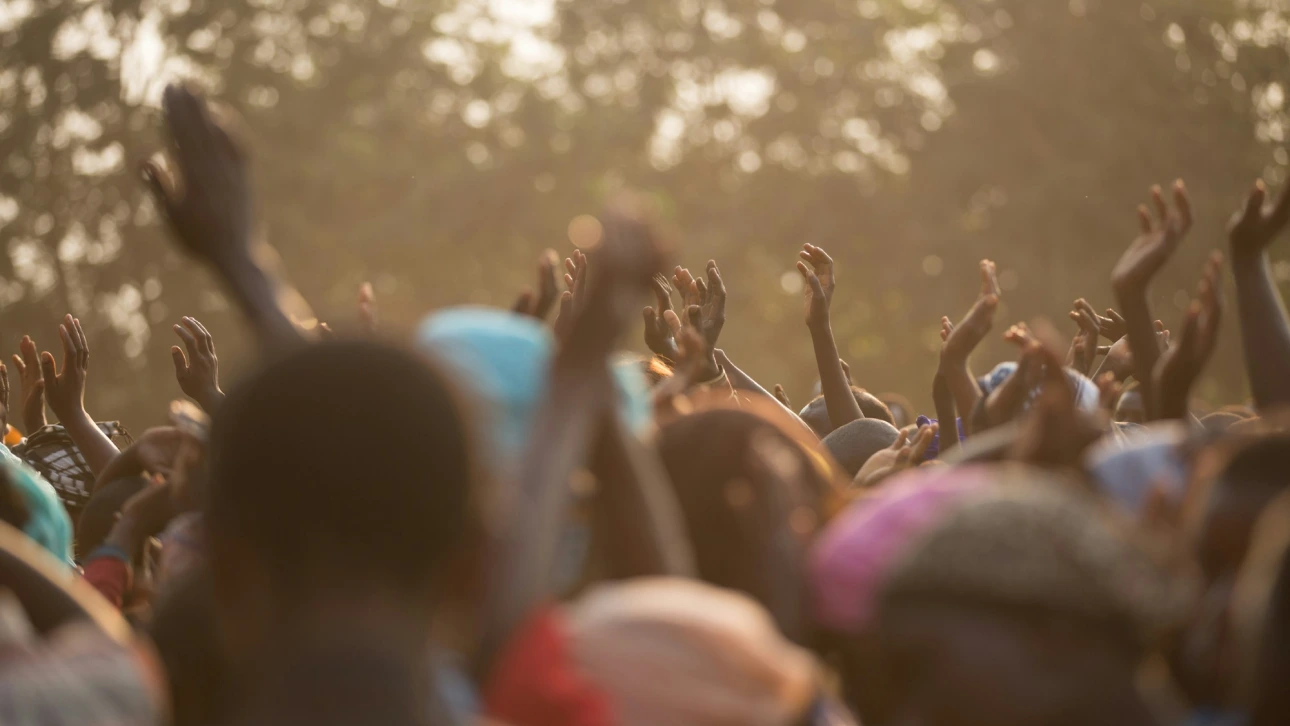 group of people with hands in the air