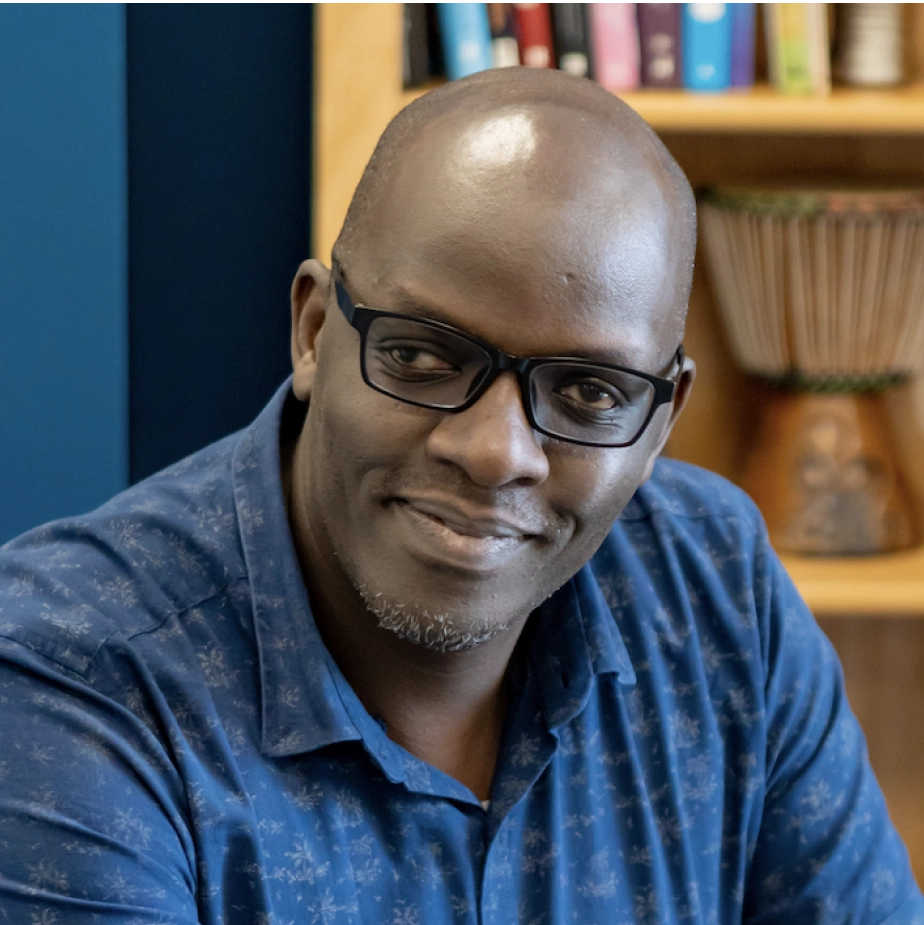 man with glasses and a blue polo