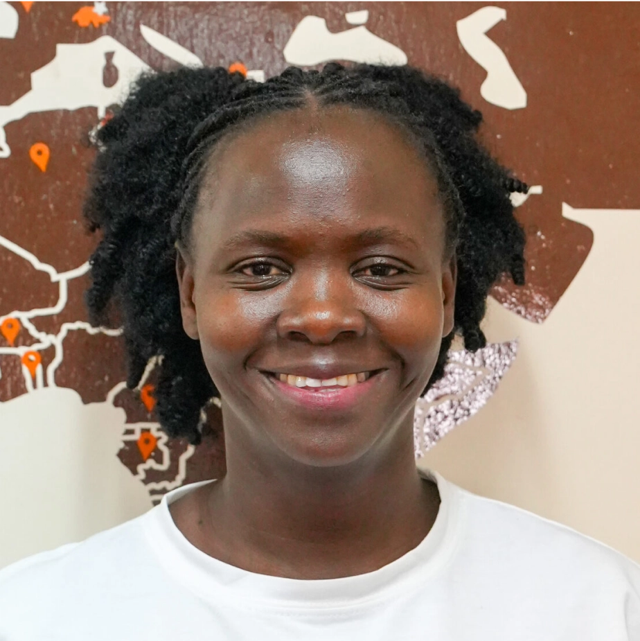 woman smiling in front of a world map