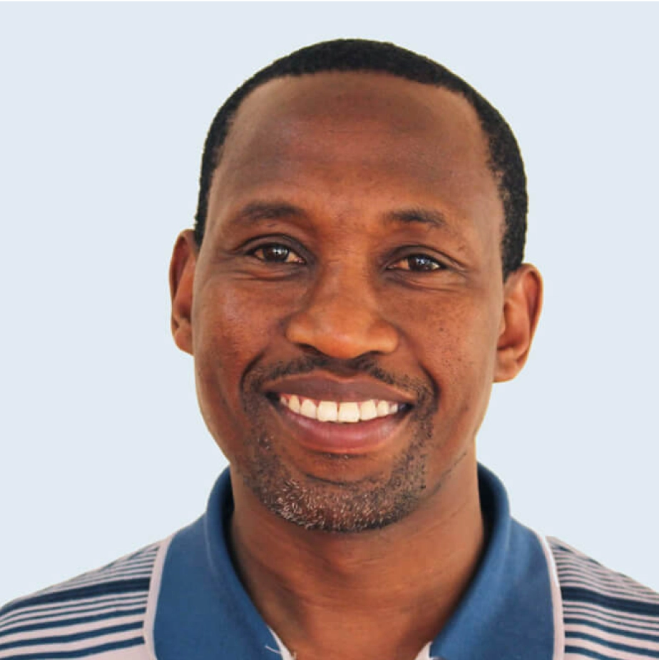 man smiling in a striped polo